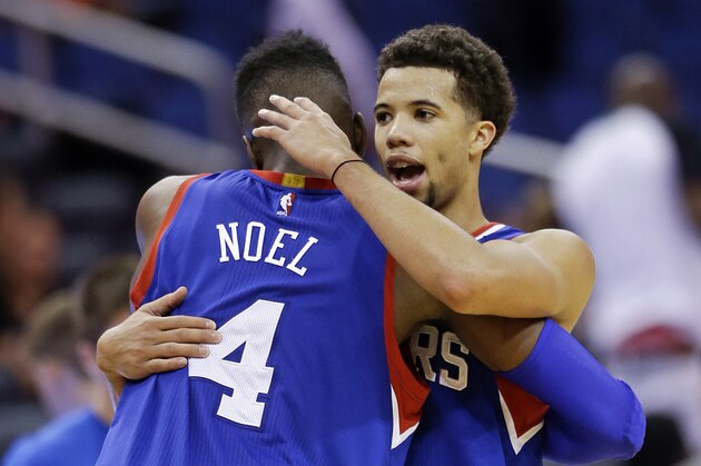 Philadelphia 76ers' Nerlens Noel (4) and Michael Carter-Williams congratulate each other after defeating the Orlando Magic 96-88 in an NBA basketball game, Sunday, Dec. 21, 2014, in Orlando, Fla. (AP Photo/John Raoux)