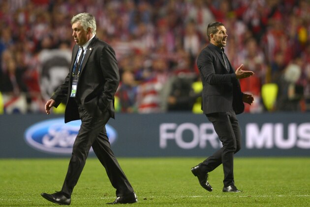 Atletico's coach Diego Simeone, left, walks by Real's coach Carlo Ancelotti, right, during the Champions League final soccer match between Atletico Madrid and Real Madrid, at the Luz stadium, in Lisbon, Portugal, Saturday, May 24, 2014. (AP Photo/Manu Fernandez)