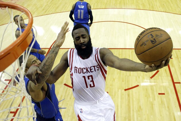 Houston Rockets' James Harden (13) goes up as Dallas Mavericks' Tyson Chandler defends during the first half of an NBA basketball game Saturday, Nov. 22, 2014, in Houston. (AP Photo/David J. Phillip)