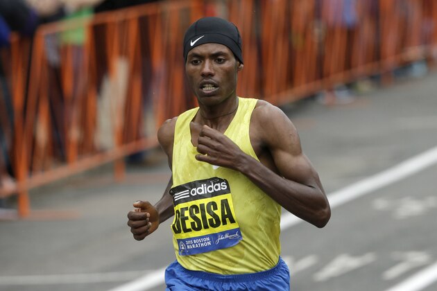 Lelisa Desisa, of Ethiopia, runs through Brookline, Mass., en route to a Boston Marathon win, Monday, April 20, 2015. (AP Photo/Steven Senne)