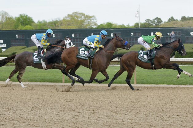 American Pharoah and jockey Victor Espinoza (6) run to the first turn between Bridget’s Big Luvy and jockey Angel Cruz (3) and Mr. Z and jockey Ramon Vazquez (2) in the $1 million Arkansas Derby horse race at Oaklawn Park in Hot Springs, Ark., Saturday, April 11, 2015. American Pharoah was the eventual winner. (AP Photo/Danny Johnston)