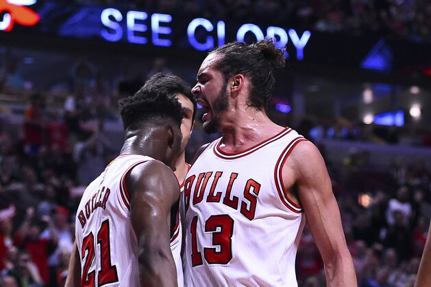 Apr 20, 2015; Chicago, IL, USA; Chicago Bulls guard Jimmy Butler (21) reacts with center Joakim Noah (13) after dunking the ball against Milwaukee Bucks center Zaza Pachulia (not pictured) during the second half in game two of the first round of the 2015 NBA Playoffs at the United Center. The Chicago Bulls defeat the Milwaukee Bucks 92-81. Mandatory Credit: Mike DiNovo-USA TODAY Sports