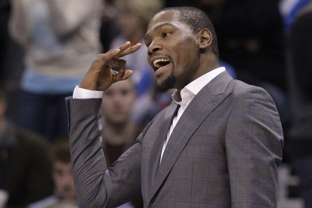 Injured Oklahoma City Thunder forward Kevin Durant gestures from the bench in the second quarter of an NBA basketball game against the Philadelphia 76ers in Oklahoma City, Wednesday, March 4, 2015. (AP Photo/Sue Ogrocki)