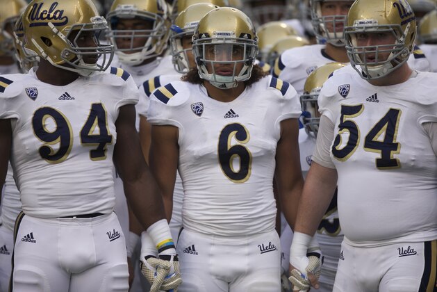 From left, UCLA defensive lineman Owamagbe Odighizuwa, linebacker Eric Kendricks and offensive lineman Jake Brendel prepare to take the field before an NCAA college football game against Washington, on Saturday, Nov. 8, 2014, in Seattle. (AP Photo/Stephen Brashear)