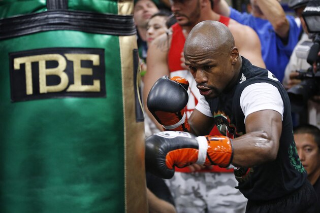 Floyd Mayweather Jr. hits a heavy bag Tuesday, April 14, 2015, in Las Vegas. Mayweather is scheduled to face Manny Pacquiao in a welterweight boxing match in Las Vegas on May 2. (AP Photo/John Locher)