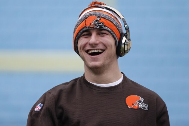 Cleveland Browns quarterback Johnny Manziel smiles as he warms up before an NFL football game against the Carolina Panthers in Charlotte, N.C., Sunday, Dec. 21, 2014. (AP Photo/Bob Leverone)