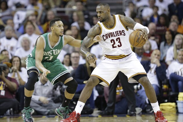 Cleveland Cavaliers' LeBron James (23) drives past Boston Celtics’ Evan Turner (11) during the first round NBA playoff basketball game Sunday, April 19, 2015, in Cleveland. (AP Photo/Tony Dejak)