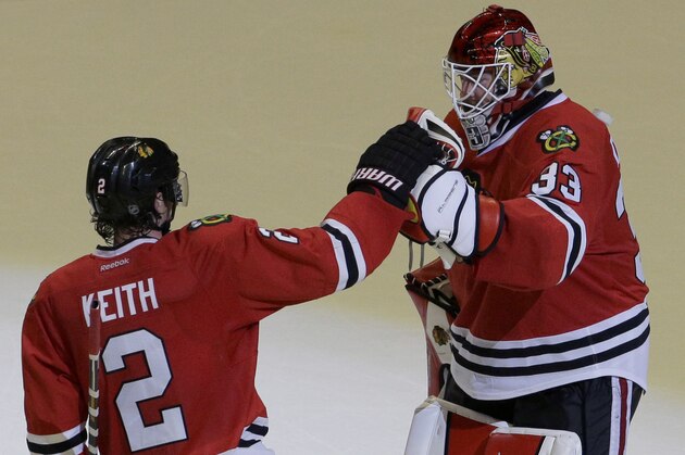 Chicago Blackhawks goalie Scott Darling, right, celebrates with defenseman Duncan Keith after the Blackhawks defeated the Nashville Predators 4-2 in Game 3 of an NHL Western Conference hockey playoff series Sunday, April 19, 2015, in Chicago. (AP Photo/Nam Y. Huh)