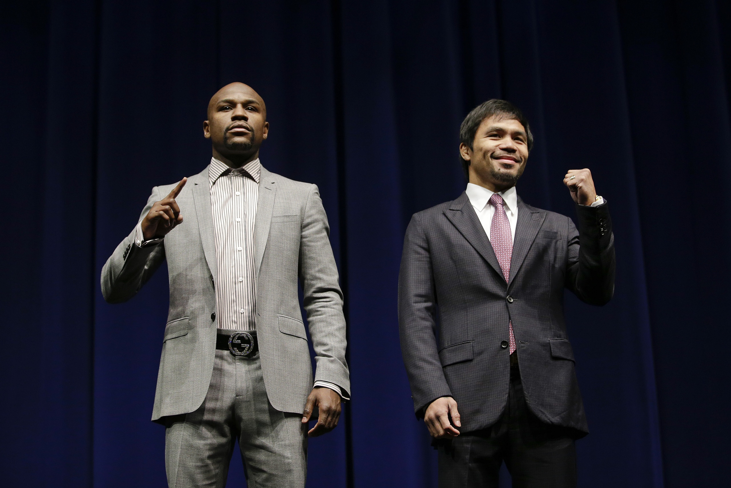 Floyd Mayweather Jr., left, and Manny Pacquiao, of the Philippines, pose for photos during a news conference, Wednesday, March 11, 2015, in Los Angeles. The two are scheduled to fight in Las Vegas on May 2. (AP Photo/Jae C. Hong)