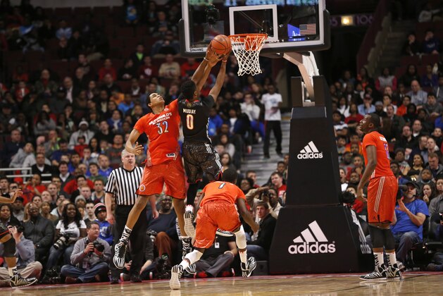 McDonald's East All-American Karl-Anthony Towns (32) attempts to block McDonald's West All-American Emmanuel Mudiay (0) as he goes up for a shot during the second half of the McDonald's All-American boy's basketball game Wednesday, April 2, 2014, in Chicago. The West won 105-102. (AP Photo/Charles Rex Arbogast)