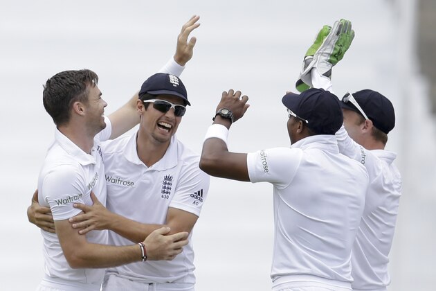 England's James Anderson, left, is congratulated by team captain Alistair Cook, second from left, Chris Jordan, second from right, and Jos Buttler on day one of their second Test match at the National Stadium in St. George's, Grenada, Tuesday, April 21, 2015. (AP Photo/Ricardo Mazalan)