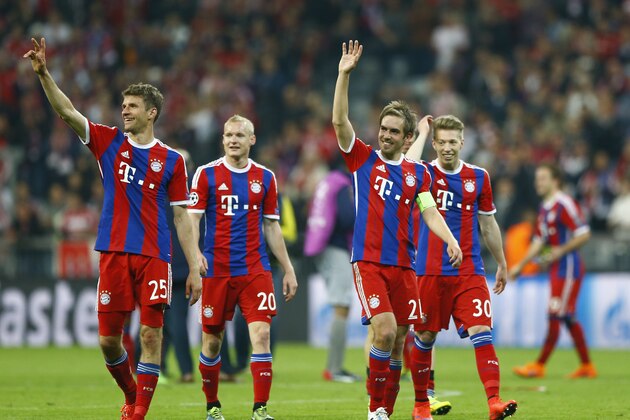 Bayern's Thomas Mueller, Sebastian Rode,  Philipp Lahm and Mitchell Weiser, from left, celebrate after winning 6-1 during the soccer Champions League quarterfinal second leg match between Bayern Munich and FC Porto at the Allianz Arena in Munich, southern Germany, Tuesday, April 21, 2015. (AP Photo/Matthias Schrader)
