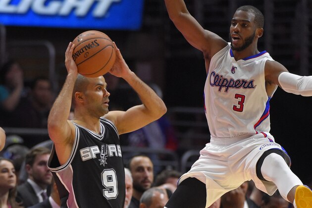 Los Angeles Clippers guard Chris Paul, right, defends as San Antonio Spurs guard Tony Parker, of France, passes during the second half of an NBA basketball game, Thursday, Feb. 19, 2015, in Los Angeles. The Clippers won 119-115. (AP Photo/Mark J. Terrill)
