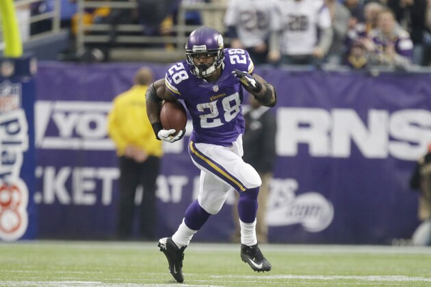Minnesota Vikings running back Adrian Peterson (28) rushes for extra yardage in an an NFL football game against the Chicago Bears, Sunday, Dec. 1, 2013, in Minneapolis. (AP Photo/Jim Mone)