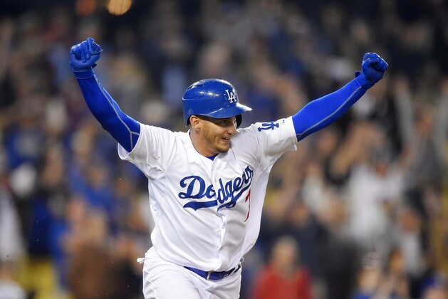 Los Angeles Dodgers' Alex Guerrero celebrates his game-winning single during the 10th inning of a baseball game against the Seattle Mariners, Monday, April 13, 2015, in Los Angeles. The Dodgers won 6-5. (AP Photo/Mark J. Terrill)