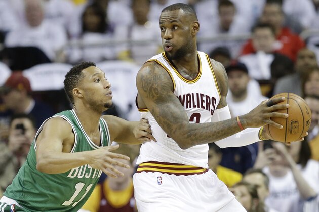 Cleveland Cavaliers' LeBron James (23) drives past Boston Celtics’ Evan Turner (11) in the first quarter of a first-round NBA playoff basketball game Tuesday, April 21, 2015, in Cleveland. (AP Photo/Mark Duncan)