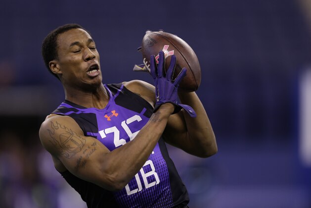 Washington defensive back Marcus Peters runs a drill at the NFL football scouting combine in Indianapolis, Monday, Feb. 23, 2015. (AP Photo/Julio Cortez)