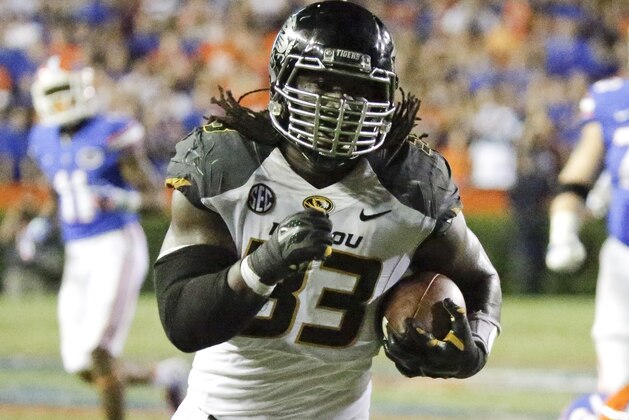 Missouri defensive lineman Markus Golden (33) runs for a 21-yard touchdown after picking up a Florida fumble during the second half of an NCAA college football game in Gainesville, Fla., Saturday, Oct. 18, 2014. Missouri won 42-13. (AP Photo/John Raoux)