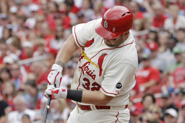 St. Louis Cardinals' Matt Adams connects for an RBI single in the first inning of a baseball game against the Cincinnati Reds, Saturday, April 18, 2015 in St. Louis. The Cardinals' Matt Holliday scored from second on the play. (AP Photo/Tom Gannam)