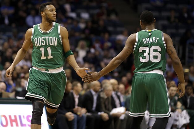Boston Celtics' Evan Turner gives Marcus Smart a high-five during an NBA basketball game against the Milwaukee Bucks Wednesday, April 15, 2015, in Milwaukee. (AP Photo/Aaron Gash)