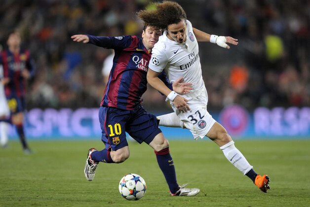 Barcelona's Lionel Messi, left, fights for the ball with PSG's David Luiz during the Champions League quarterfinal second leg soccer match between FC Barcelona and Paris Saint Germain at the Camp Nou Stadium in Barcelona, Spain, Tuesday, April 21, 2015. (AP Photo/Manu Fernandez)
