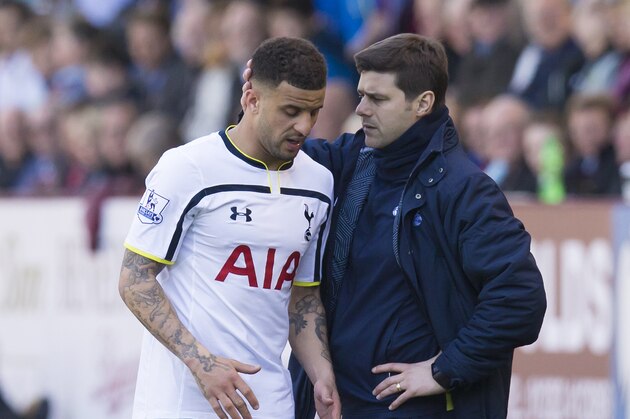 Tottenham's Kyle Walker, left, is consoled by manager Mauricio Pochettino as he walks injured from the pitch during the English Premier League soccer match between Burnley and Tottenham at Turf Moor Stadium, Burnley, England, Sunday April 5, 2015. (AP Photo/Jon Super)