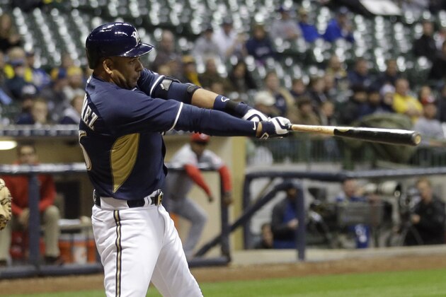 Milwaukee Brewers' Aramis Ramirez hits a single during the sixth inning of a baseball game against the Cincinnati Reds Tuesday, April 21, 2015, in Milwaukee. (AP Photo/Morry Gash)