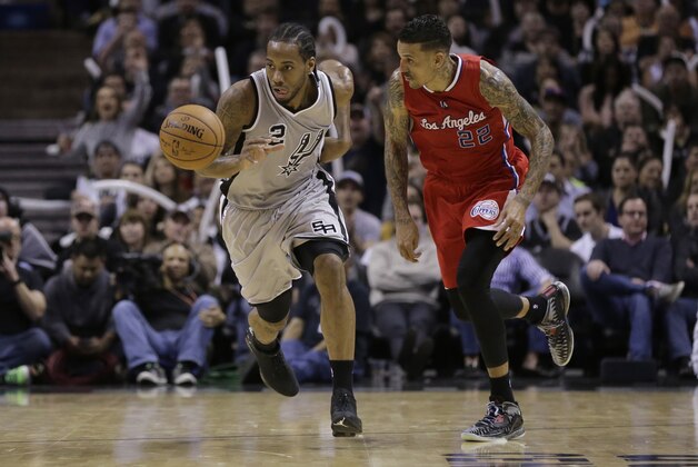 San Antonio Spurs’ Kawhi Leonard (2) takes the ball up court as Los Angeles Clippers’ Matt Barnes (22) follows during the second half of an NBA basketball game, Saturday, Jan. 31, 2015, in San Antonio. Los Angeles won 105-85. (AP Photo/Eric Gay)
