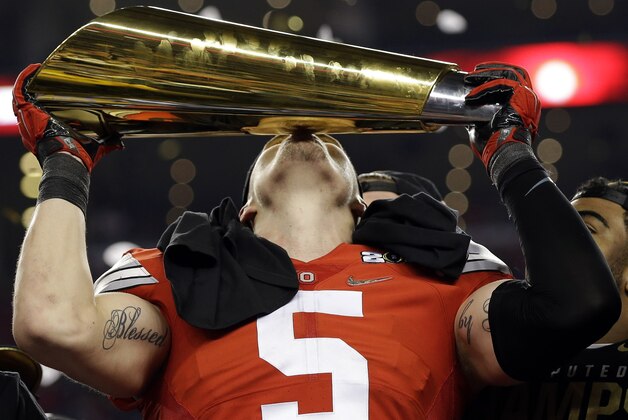 Ohio State's Jeff Heuerman holds the championship trophy after the NCAA college football playoff championship game against Oregon Monday, Jan. 12, 2015, in Arlington, Texas. Ohio State won 42-20. (AP Photo/David J. Phillip)