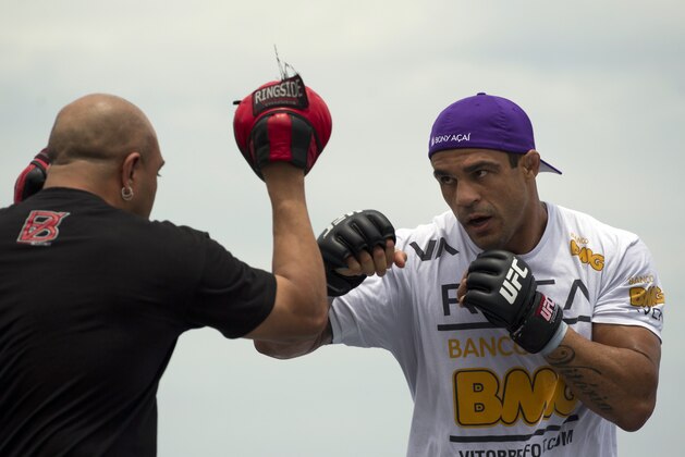 Vitor Belfort, of Brazil, right, trains during UFC Rio Open Workouts on Barra de Tijuca Beach in Rio de Janeiro, Brazil, Wednesday Jan. 11, 2012.  Belfort will face Anthony Johnson, of the U.S., on Jan. 14 at the Ultimate Fighting Championship's UFC 142, the organization's second event in Rio de Janeiro.  (AP Photo/Felipe Dana)