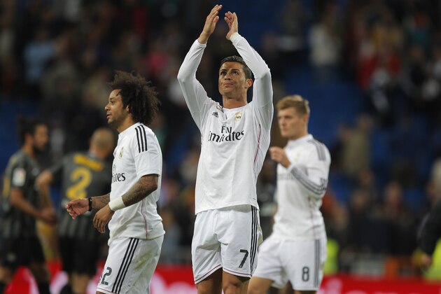 Real Madrid's Cristiano Ronaldo, centre, celebrates with, team mates during a Spanish La Liga soccer match between Real Madrid and Malaga at the Santiago Bernabeu stadium in Madrid, Spain, Saturday, April 18, 2015. (AP Photo/Andres Kudacki)