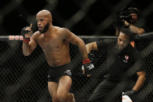 Demetrious Johnson celebrates after defeating Chris Cariaso in their flyweight mixed martial arts title bout at UFC 178 on Saturday, Sept. 27, 2014, in Las Vegas. (AP Photo/John Locher)