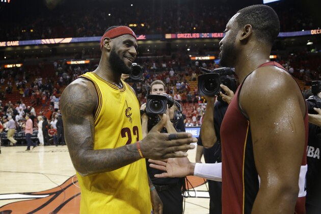 Cleveland Cavaliers forward LeBron James (23) and Miami Heat guard Dwyane Wade shakes hands after an NBA basketball game, Thursday, Dec. 25, 2014, in Miami. The Heat defeated the Cavaliers 101-91. (AP Photo/Lynne Sladky)