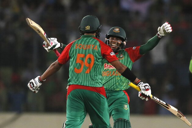 Bangladesh’s Mushfiqur Rahim, face to camera, and Soumya Sarkar prepare to embrace after winning the third one-day international cricket match against Pakistan in Dhaka, Bangladesh, Wednesday, April 22, 2015. (AP Photo/ A.M. Ahad)