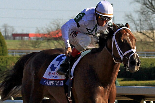 Favorite Carpe Diem, ridden by jockey John Velazquez, draws off to win the Blue Grass Stakes horse race at Keeneland Race Course in Lexington, Ky., Saturday, April  4, 2015.  (AP Photo/Garry Jones)