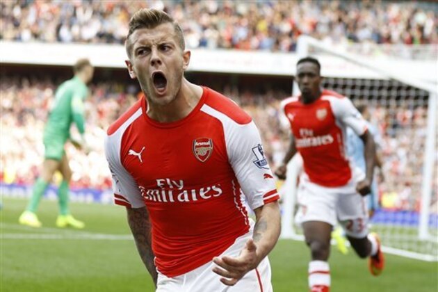 Arsenal's Jack Wilshere celebrates scoring a goal during the English Premier League soccer match between Arsenal and Manchester City at Emirates Stadium in London, Saturday, Sept. 13, 2014. (AP Photo/Kirsty Wigglesworth)