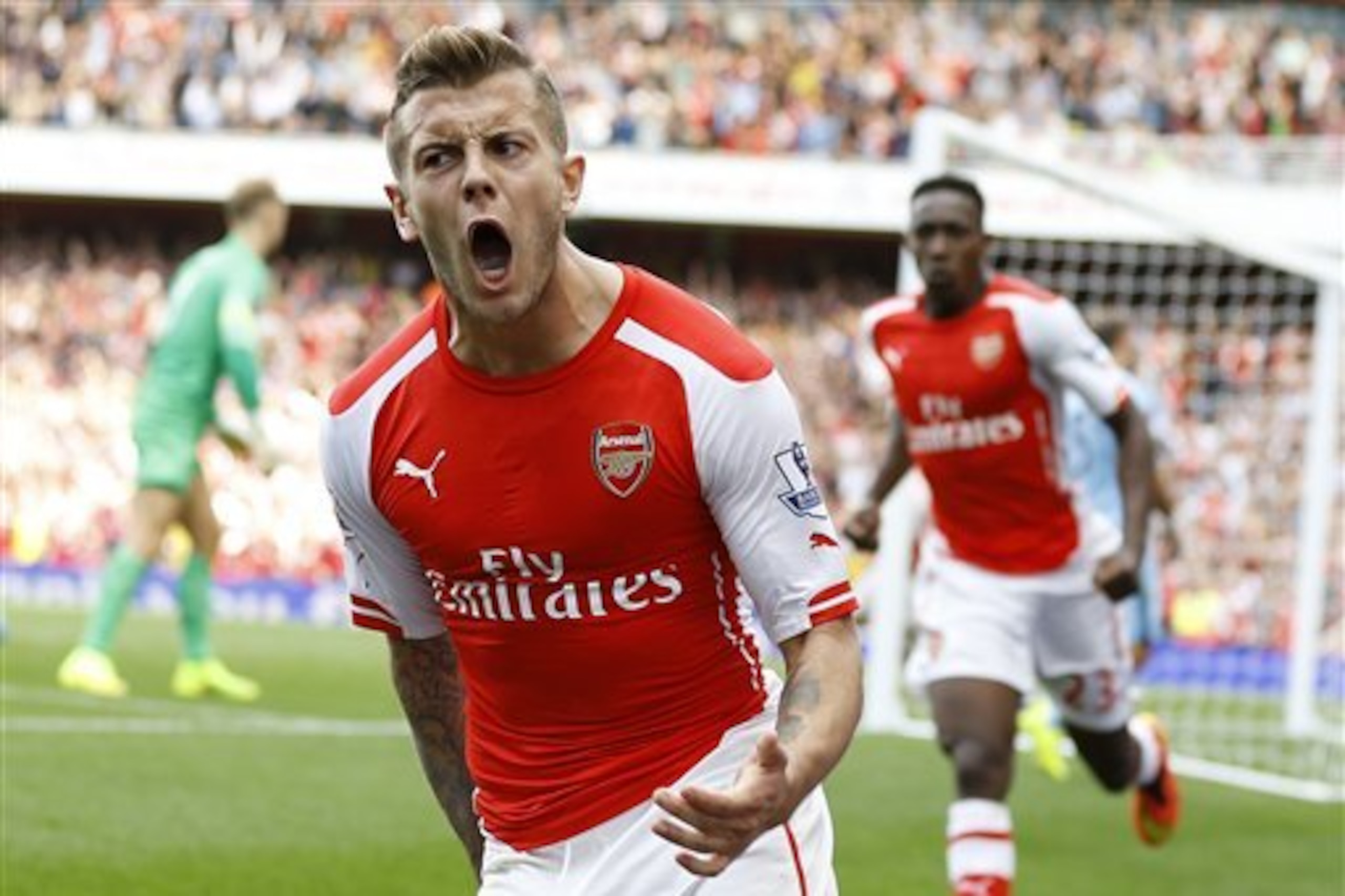 Arsenal's Jack Wilshere celebrates scoring a goal during the English Premier League soccer match between Arsenal and Manchester City at Emirates Stadium in London, Saturday, Sept. 13, 2014. (AP Photo/Kirsty Wigglesworth)