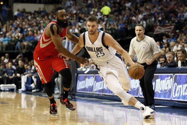 Houston Rockets' James Harden, left, defends as Dallas Mavericks' Chandler Parsons (25) moves up court in the second half of an NBA basketball game Thursday, April 2, 2015, in Dallas. (AP Photo/Tony Gutierrez)