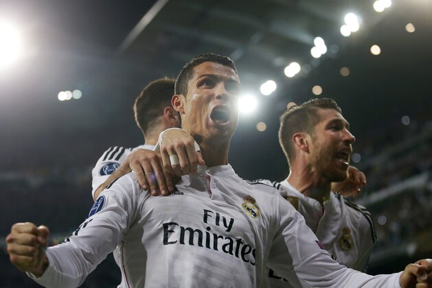 Real Madrid's Cristiano Ronaldo and Real Madrid's Sergio Ramos celebrate after scoring 1-0 during the second leg quarterfinal Champions League soccer match between Real Madrid and Atletico Madrid at Santiago Bernabeu stadium in Madrid, Spain, Wednesday April 22, 2015. Real won the match with a 1-0 score and continues to play the semifinal. (AP Photo/Paul White)