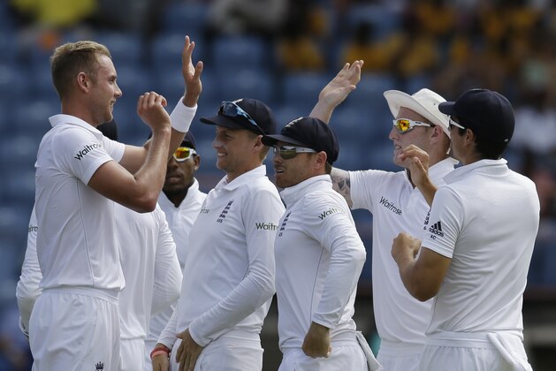 England's Stuart Broad, left, celebrates with teammates Joe Root, second from left, Ian Bell, third from left, Ben Stokes, second from right, and Alistair Cook, right, after taking the wicket of West Indies' Jason Holder on day two of their second Test match at the National Stadium in St. George's, Grenada, Wednesday, April 22, 2015. (AP Photo/Ricardo Mazalan)