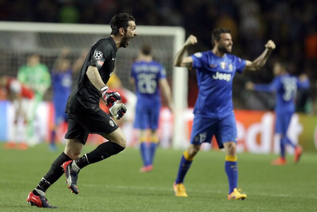 Juventus goalkeeper Gianluigi Buffon, left, and his teammate Andrea Barzagli celebrate their victory after the final whistle of the Champions League quarterfinal second leg soccer match between Monaco and Juventus at Louis II stadium in Monaco, Wednesday, April 22, 2015. (AP Photo/Lionel Cironneau)