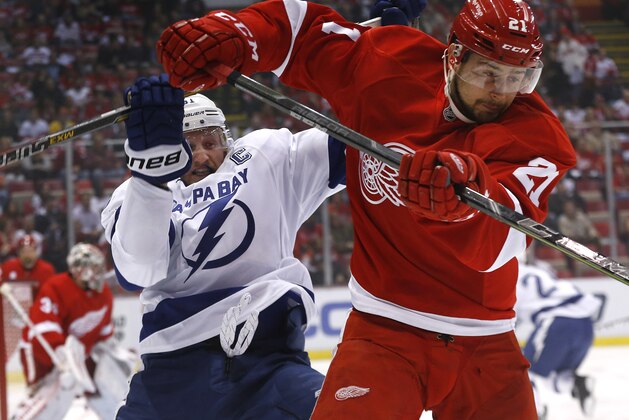 Tampa Bay Lightning center Steven Stamkos, left, and Detroit Red Wings left wing Tomas Tatar collide during the first period of Game 3 of a first-round NHL Stanley Cup hockey playoff series  in Detroit Tuesday, April 21, 2015. (AP Photo/Paul Sancya)