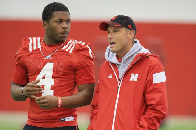 Nebraska head coach Mike Riley and quarterback Tommy Armstrong Jr. (4) talk during NCAA college football spring practice in Lincoln, Neb., Wednesday, March 18, 2015. Nebraska is two weeks into spring practice, and coach Riley said the team is progressing about like he expected it would. He said the quarterbacks need to complete a higher percentage of passes and cut down on interceptions . (AP Photo/Nati Harnik)