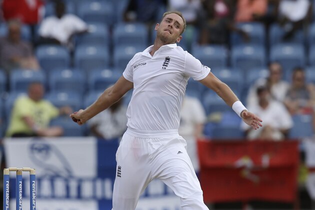England's Stuart Broad, right, bowls under the watch of West Indies' Devendra Bishoo on day two of their second Test match at the National Stadium in St. George's, Grenada, Wednesday, April 22, 2015. (AP Photo/Ricardo Mazalan)