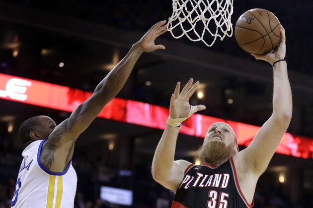 Portland Trail Blazers' Chris Kaman, right, shoots over Golden State Warriors' Andre Iguodala during the first half of an NBA basketball game Thursday, April 9, 2015, in Oakland, Calif. (AP Photo/Ben Margot)