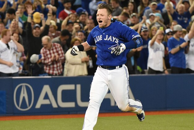 Apr 18, 2015; Toronto, Ontario, CAN;  Toronto Blue Jays third baseman Josh Donaldson (20) reacts as he arrives at home plate after hitting a home run in the 10th inning to give the Jays a 6-5 win over Atlanta Braves at Rogers Centre. Mandatory Credit: Dan Hamilton-USA TODAY Sports