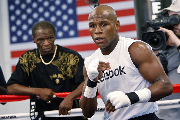 FILE - In this Sept. 19, 2009, file photo, boxier Floyd Mayweather Jr., right, works out at his gym as his father, Floyd Mayweather Sr., left, looks on in Las Vegas. He taught his son to throw punches before he could walk, and he'll be in his corner for the biggest fight of his life against Manny Pacquiao on May 2. The relationship betwee Mayweather Sr. and his son, though, hasn't always been good. (AP Photo/Isaac Brekken, File0