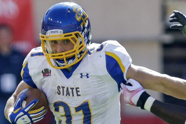 South Dakota State running back Zach Zenner (31) runs past the tackle of Nebraska defensive end Greg McMullen (90) in the first half of an NCAA college football game in Lincoln, Neb., Saturday, Sept. 21, 2013. (AP Photo/Nati Harnik)