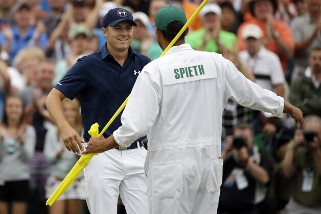Jordan Spieth celebrates with his caddie Michael Greller after winning the Masters golf tournament Sunday, April 12, 2015, in Augusta, Ga. (AP Photo/Matt Slocum)
