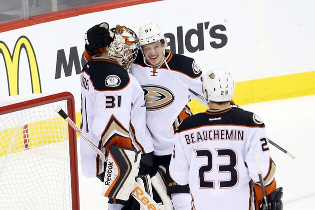 Apr 22, 2015; Winnipeg, Manitoba, CAN; Anaheim Ducks center Rickard Rakell (67) celebrates with goalie Frederik Andersen (31) after the third period in game four of the first round of the 2015 Stanley Cup Playoffs against the Winnipeg Jets at MTS Centre. Anaheim wins the game 5-2 and sweeps the series 4-0. Mandatory Credit: Bruce Fedyck-USA TODAY Sports